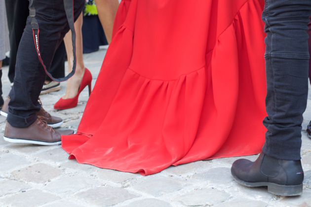 Red dress dragging on sidewalk