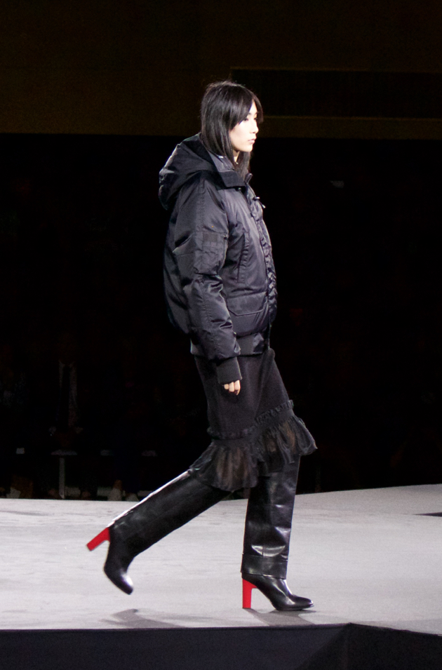 Opening Ceremony - Canada Goose parka with black ruffle skirt and stovepipe boot