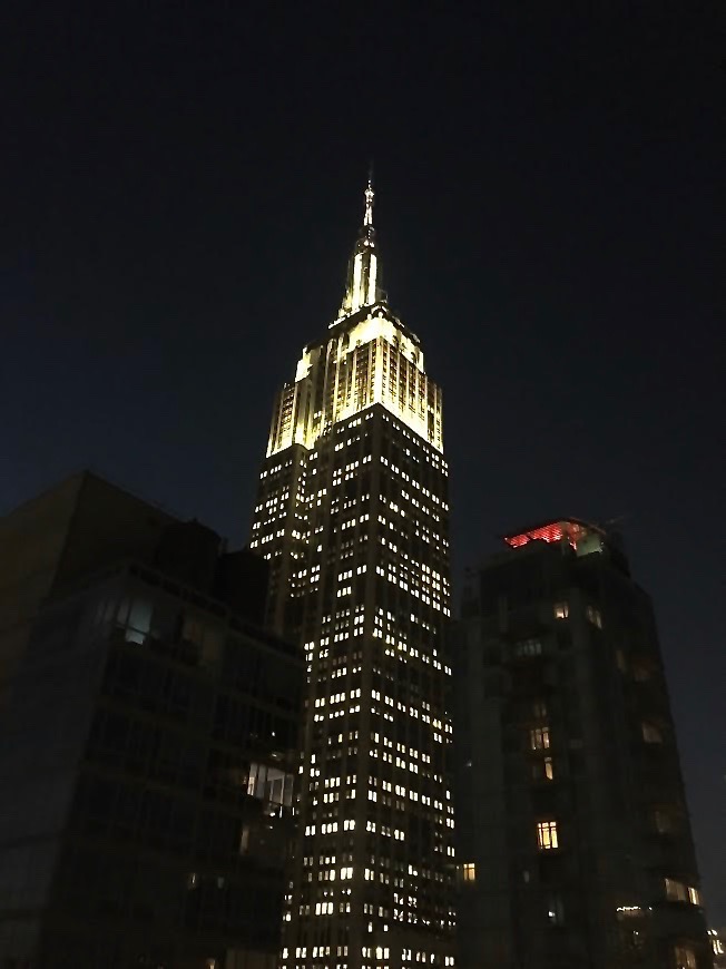 View of Empire State Building at night from Arlo Hotel rooftop in NYC.