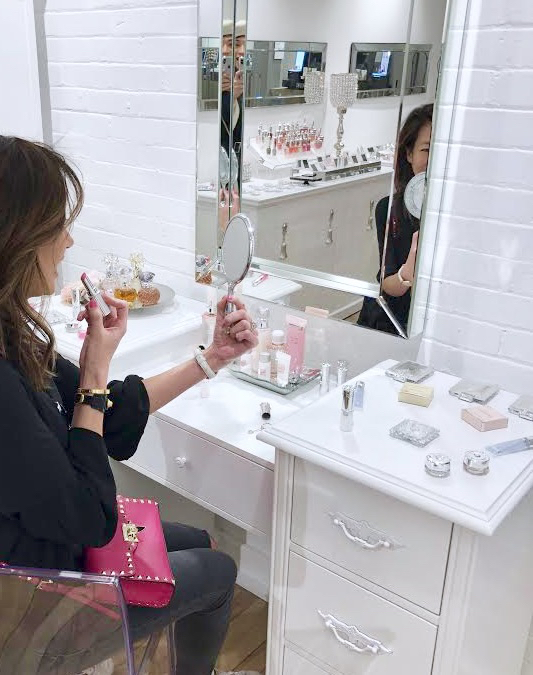 Jill Stuart Beauty Soho Showroom, Sitting at vanity and trying on Lip Blossom.