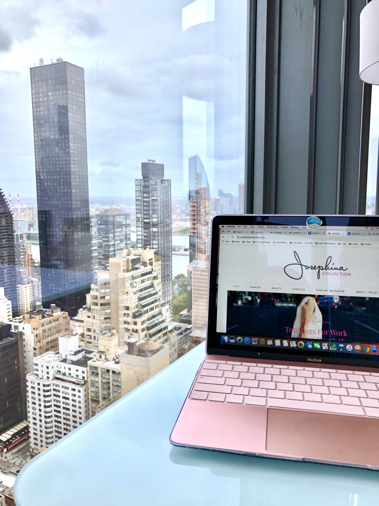 Home and Office Faves to Buy Now Post, Working on a laptop with a penthouse view of NYC